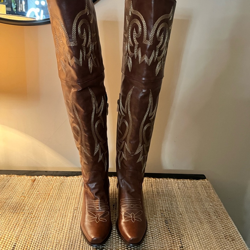 Women’s thigh high brown cowgirl boots 3 inch heel.